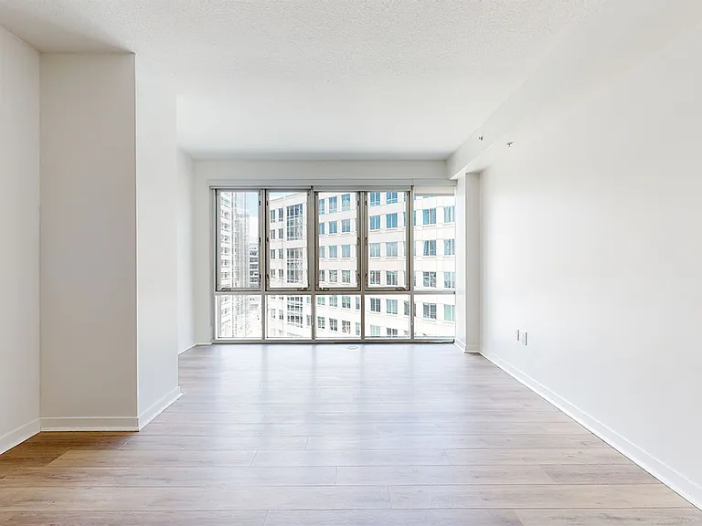 Apartment dining and living room with wood-style flooring.