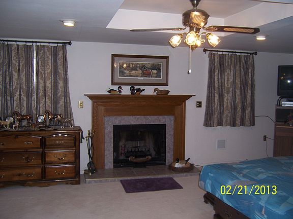 wood fireplace in lg bedroom