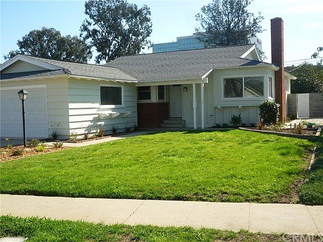 Front yard and newly painted house with newer double paned windows throughout.
