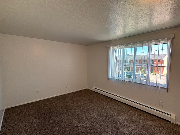 Master bedroom with new window and vertical shade.