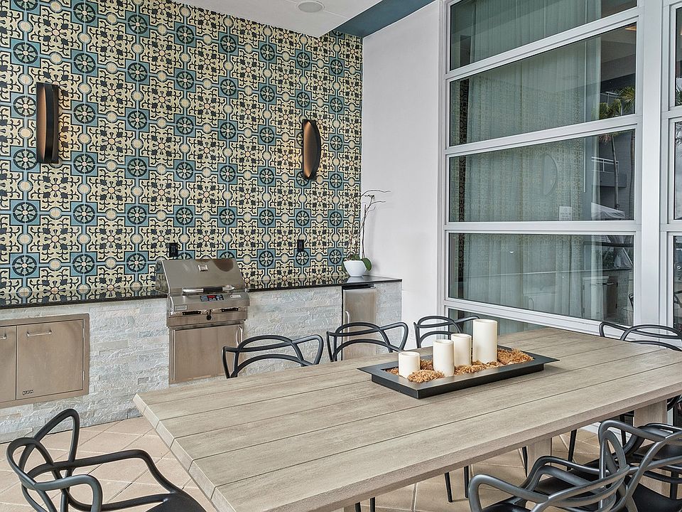 Dine al fresco in refined comfort, just steps from the water