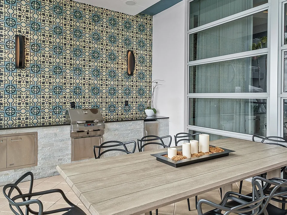 Dine al fresco in refined comfort, just steps from the water