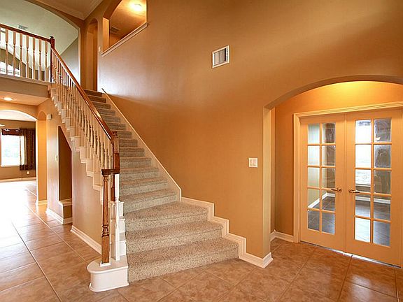 Study off the entrance with French doors and ceramic tile.