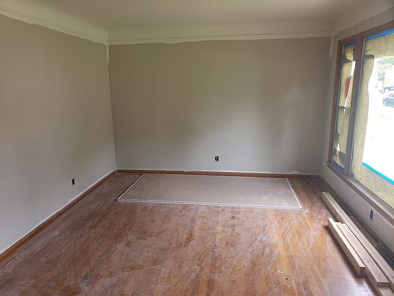 Living room freshly painted. Awaiting the natural hardwood floors to be refinished