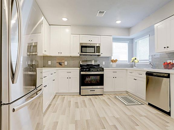Open concept kitchen with marble countertops.