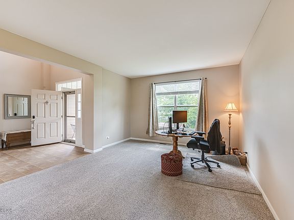The living room is adjacent to the foyer and overlooks the front yard.