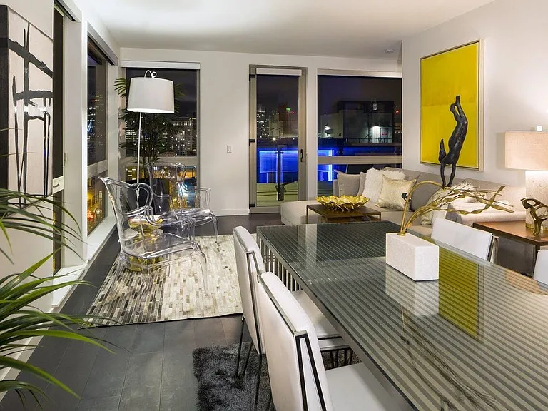 Apartment Dining and Living Room with City Skyline View Through Windows