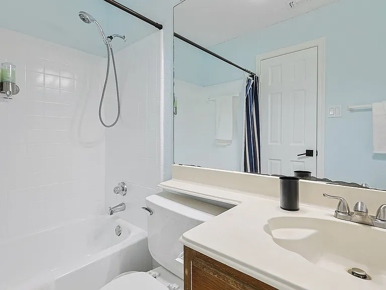 Full Bathroom 1 - shower-tub combo and bathroom essentials.