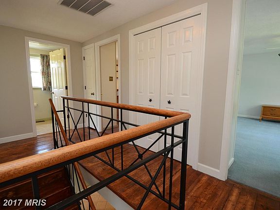 Upstairs hall with iron railings and custom floors