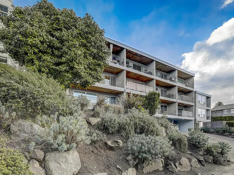 An exterior view of the building showcasing its architectural details and well-maintained landscaping, creating an inviting and aesthetically pleasing environment.