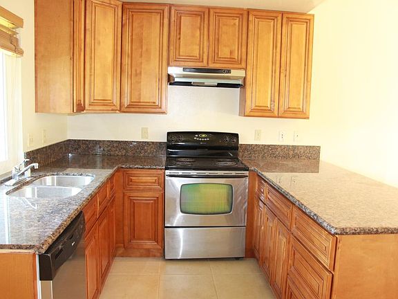 New granite counter tops, wood cabinets, stainless sink, dis