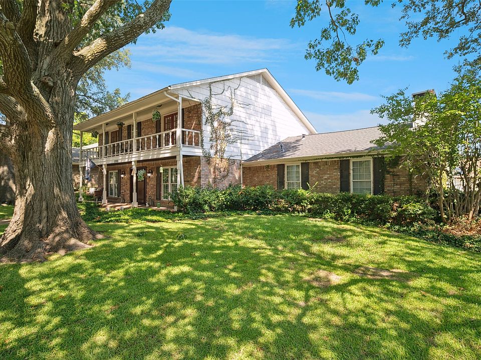 Captivating view from an angle with a majestic tree in the front yard