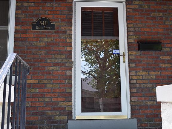 Beautiful custom address plaque at front door along with a convenient storm door!