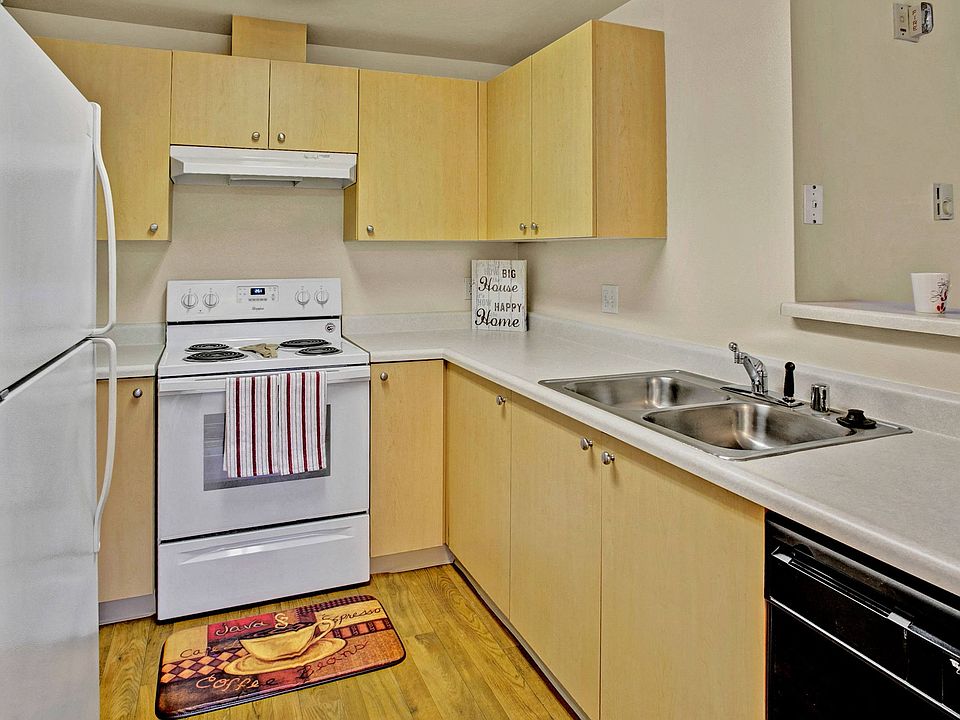 A kitchen with lots of counter space cabinet storage, and a bar
