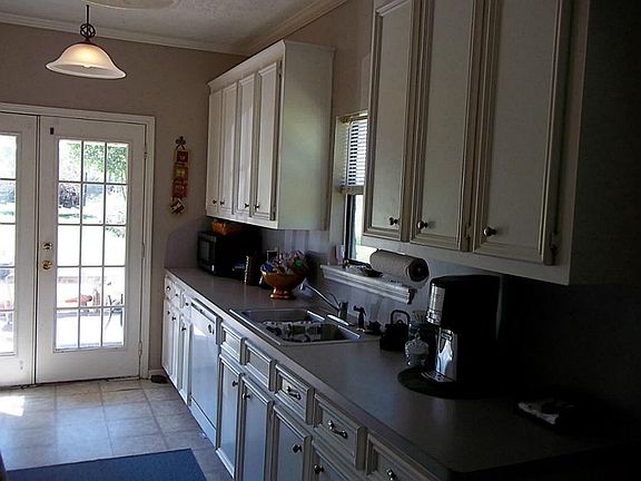 Kitchen w/lots of cabinets and french doors out to covered porch