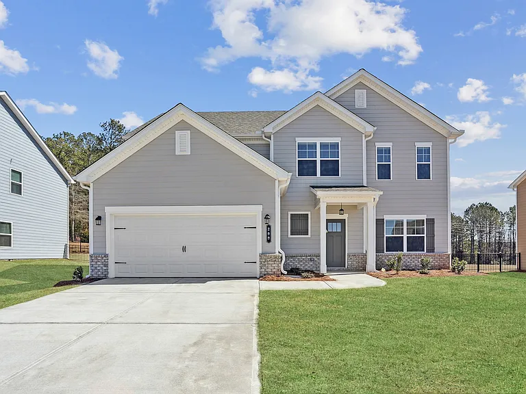 Exterior of the Southport, two story home with a private driveway and attached garage.