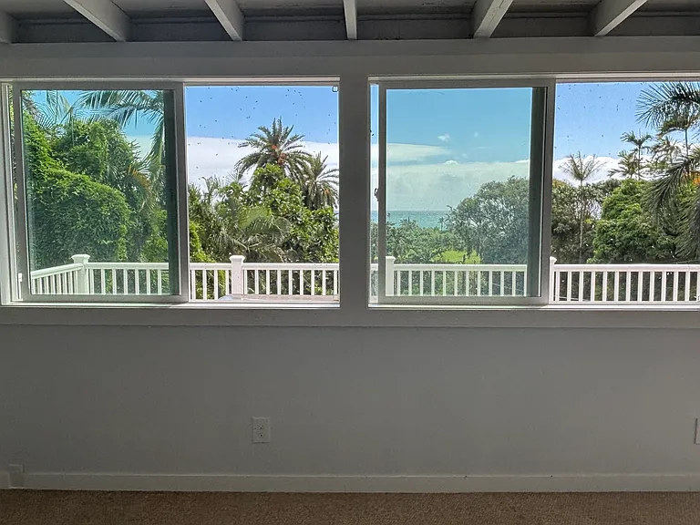 Views of large green lawn in front of home with ocean views beyond and awesome sunrises every morning!