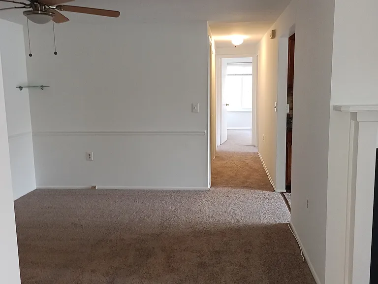 dining area with ceiling fan and new carpeted area