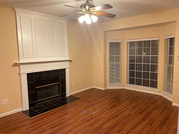 Spacious living area with fireplace and fan