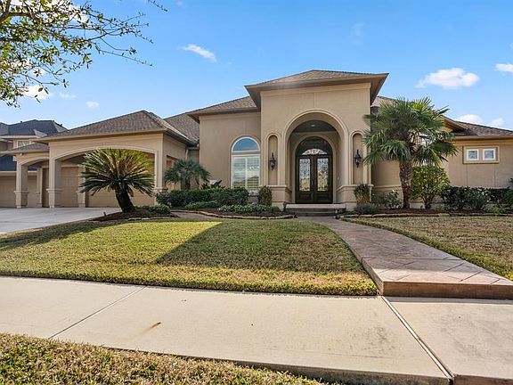 Gorgeous elevation, with a stucco exterior on a corner lot, 3-car garage on a triple wide driveway.
