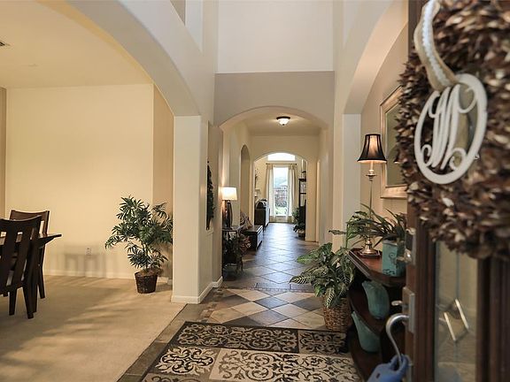 Designer tile design greets you in the spacious foyer. Flanked by dining room.