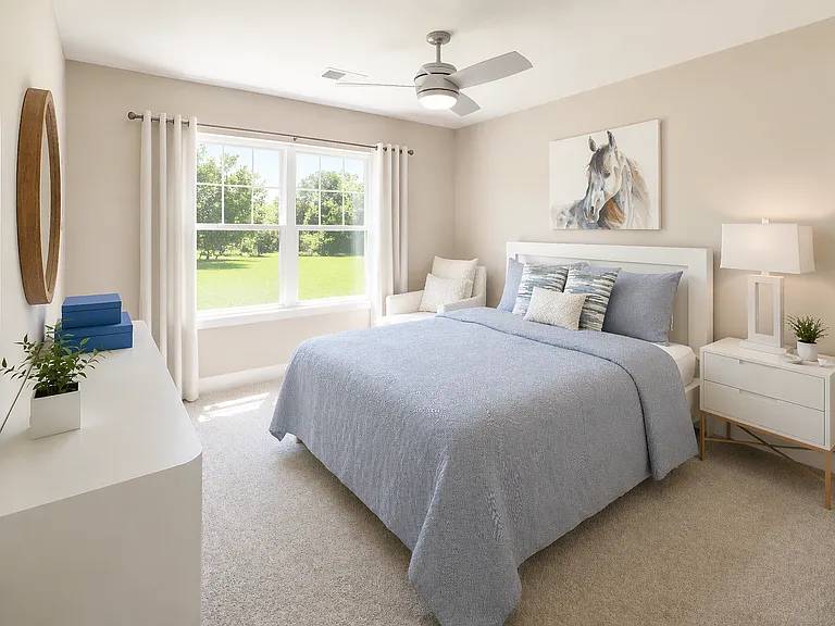 Light-filled bedroom with large window, neutral tones, and spacious layout for comfortable everyday living.