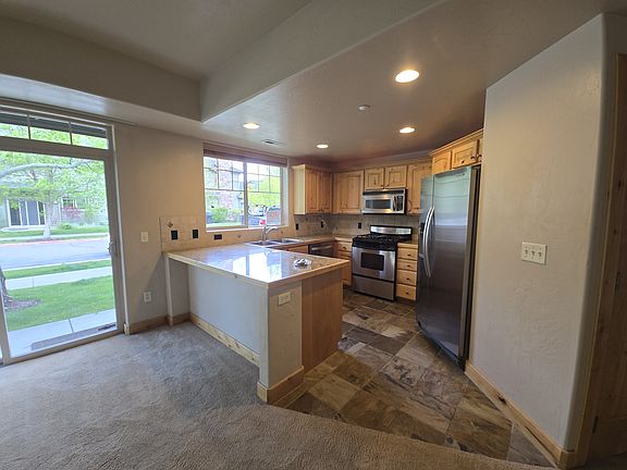 Kitchen with slate floor and slider- doors to Barbeque area and outdoor patio