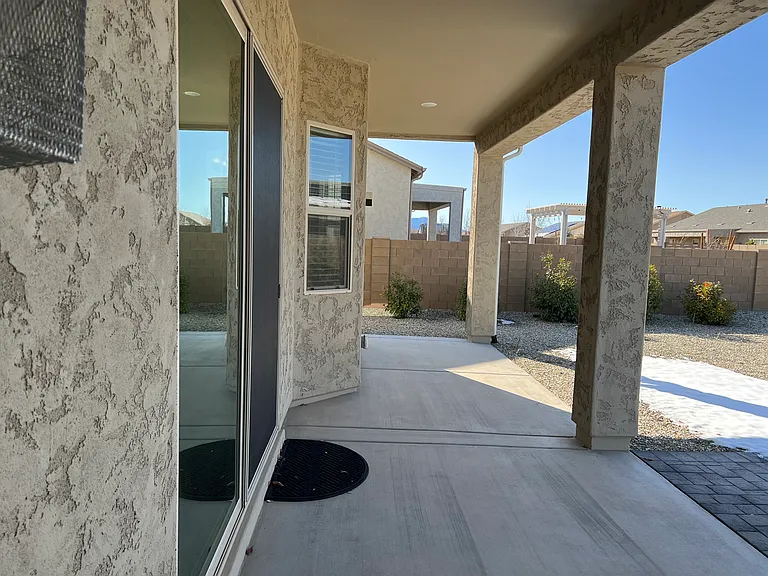 Long Covered Patio with Open Extension Area of Pavers.