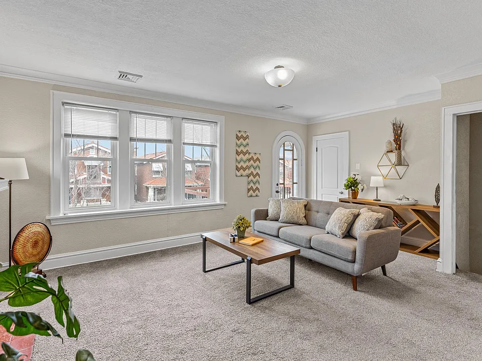Relax by the window on the comfy couch with a convenient table, perfect for enjoying the view.