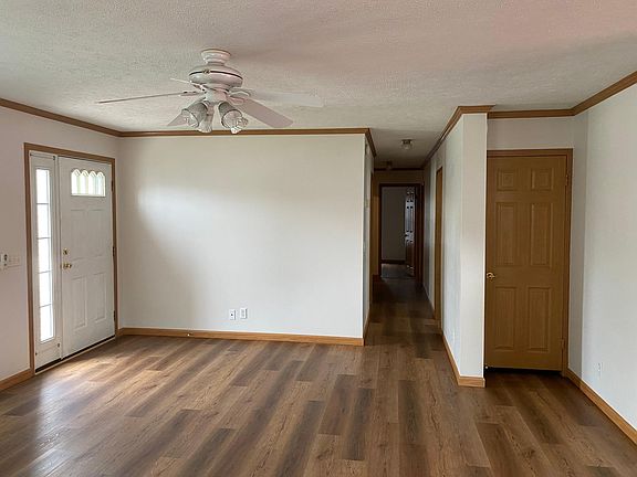 Living area looking down hallway leading to bathroom, bedrooms and to the laundry room and garage exit.