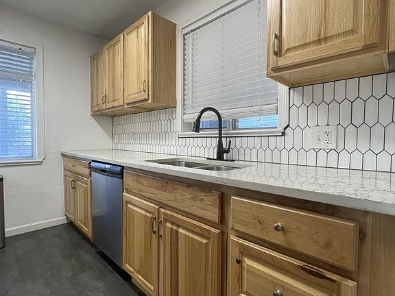 Quartz countertops and marble backsplash