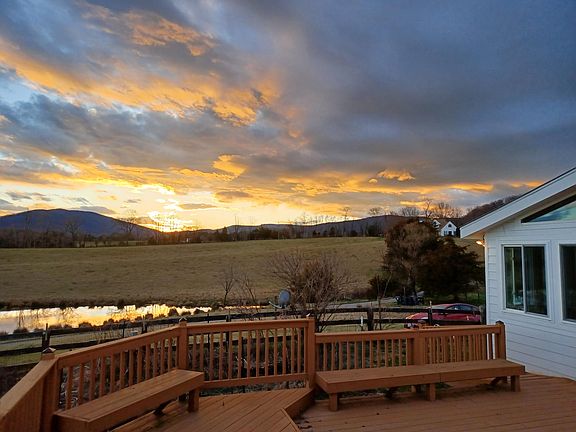 Sunset over the Blue Ridge Mountains from the cottage deck overlooking lake.