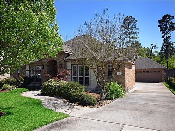 Long driveway leading to detached garage which offers