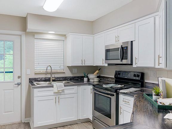 Open concept kitchens featuring wood-style flooring and breakfast bar.