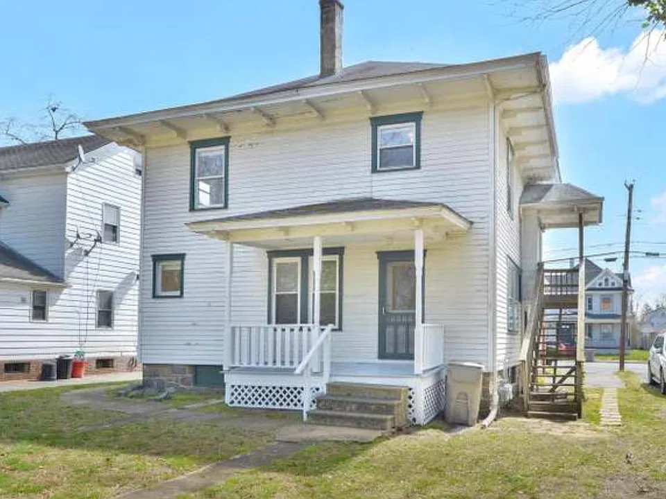 Back view with staircase access to upstair unit entrance