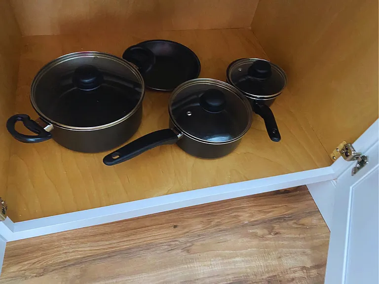 Kitchen includes all essentials such as pots, pans, and cooking utensils.