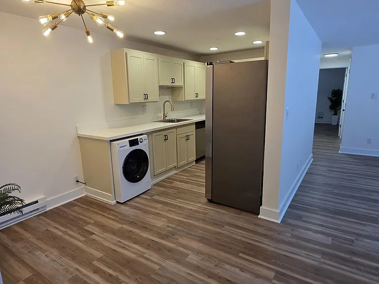 Entry opens to living room and kitchen