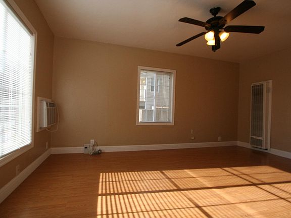 Living room with ceiling fan and plenty of natural lighting