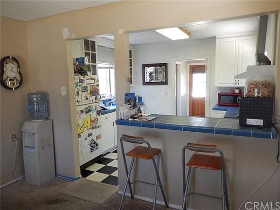 Front house view from dining area across bar through kitchen to back door