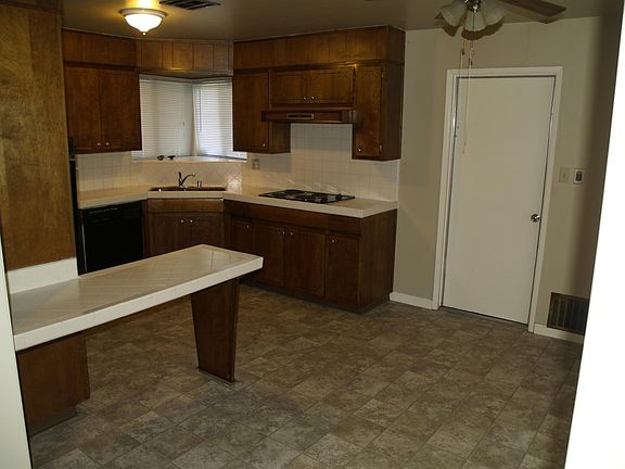 Kitchen view from family room. Door to garage at right.