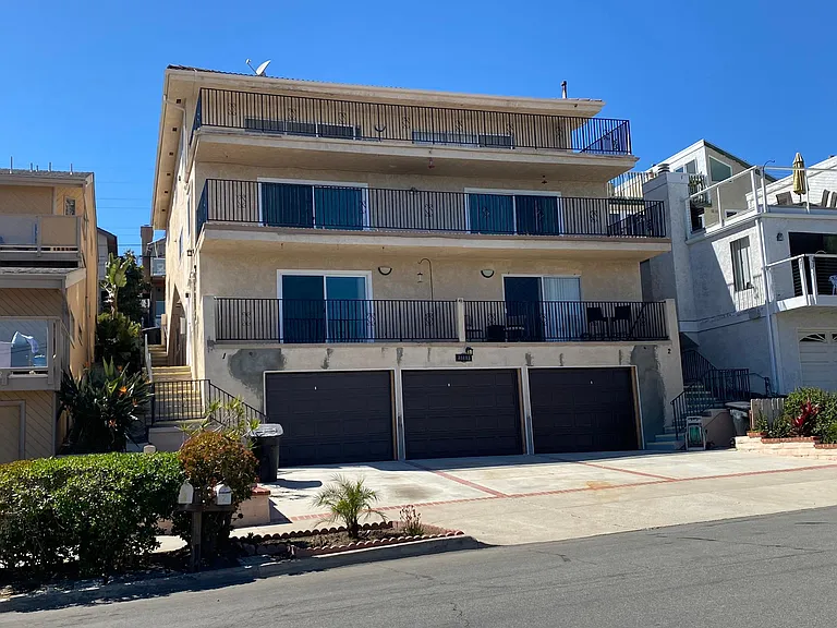 1 bedroom is on far Left above the single car garage. Exterior building has touch up paint in progress. Stairs to the left leed to front door. Concrete flooring between upper and lower units creating a sound barrier.
