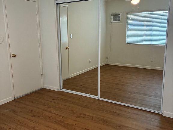 Ceiling fans in both bedrooms and large storage behind mirrored sliding glass doors.