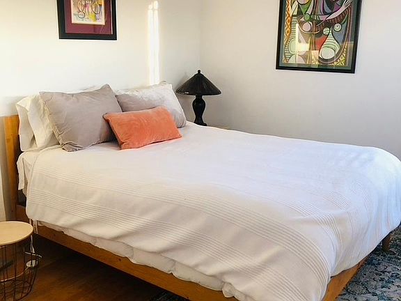 Main bedroom with views of Hollywood sign and DTLA. Queen bed