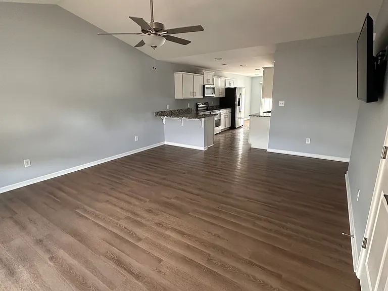 Large living room with TV mounted on wall