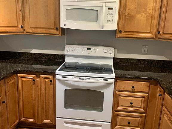 Kitchen includes granite counter tops, microwave, refrigerator, oven with glass stove top, dishwasher, 
garbage disposal, and plenty of storage.