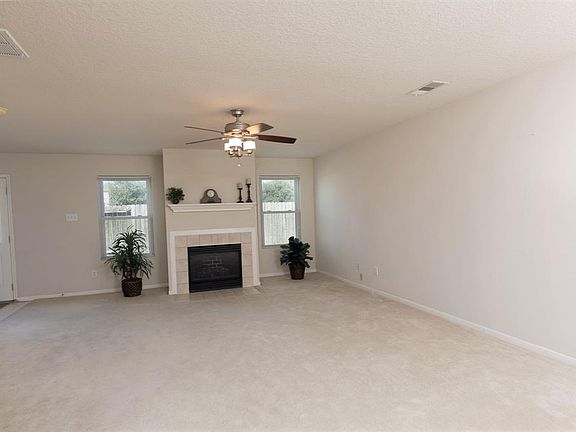 Enter into large living area with gas log fireplace.
