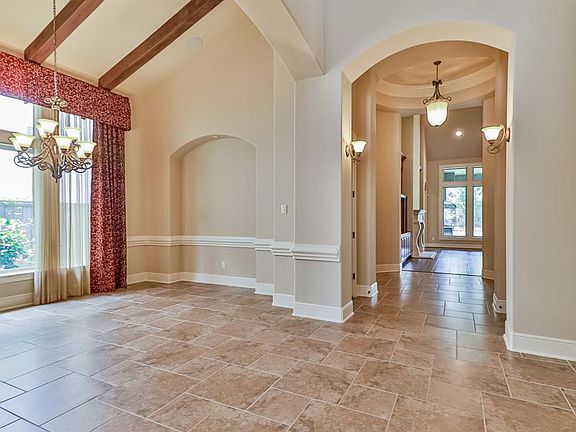 Exquisite foyer features an open passage way to the formal dining