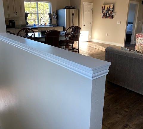 Top of the stairs looking into living room and kitchen