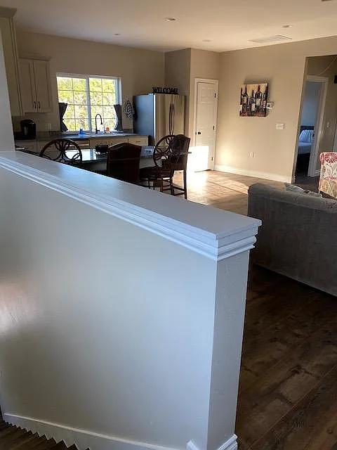 Top of the stairs looking into living room and kitchen
