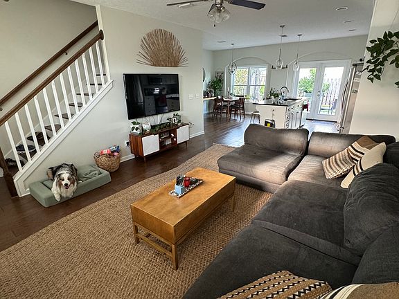 Open concept living room and kitchen, view of the backyard, stairs to the 2nd floor